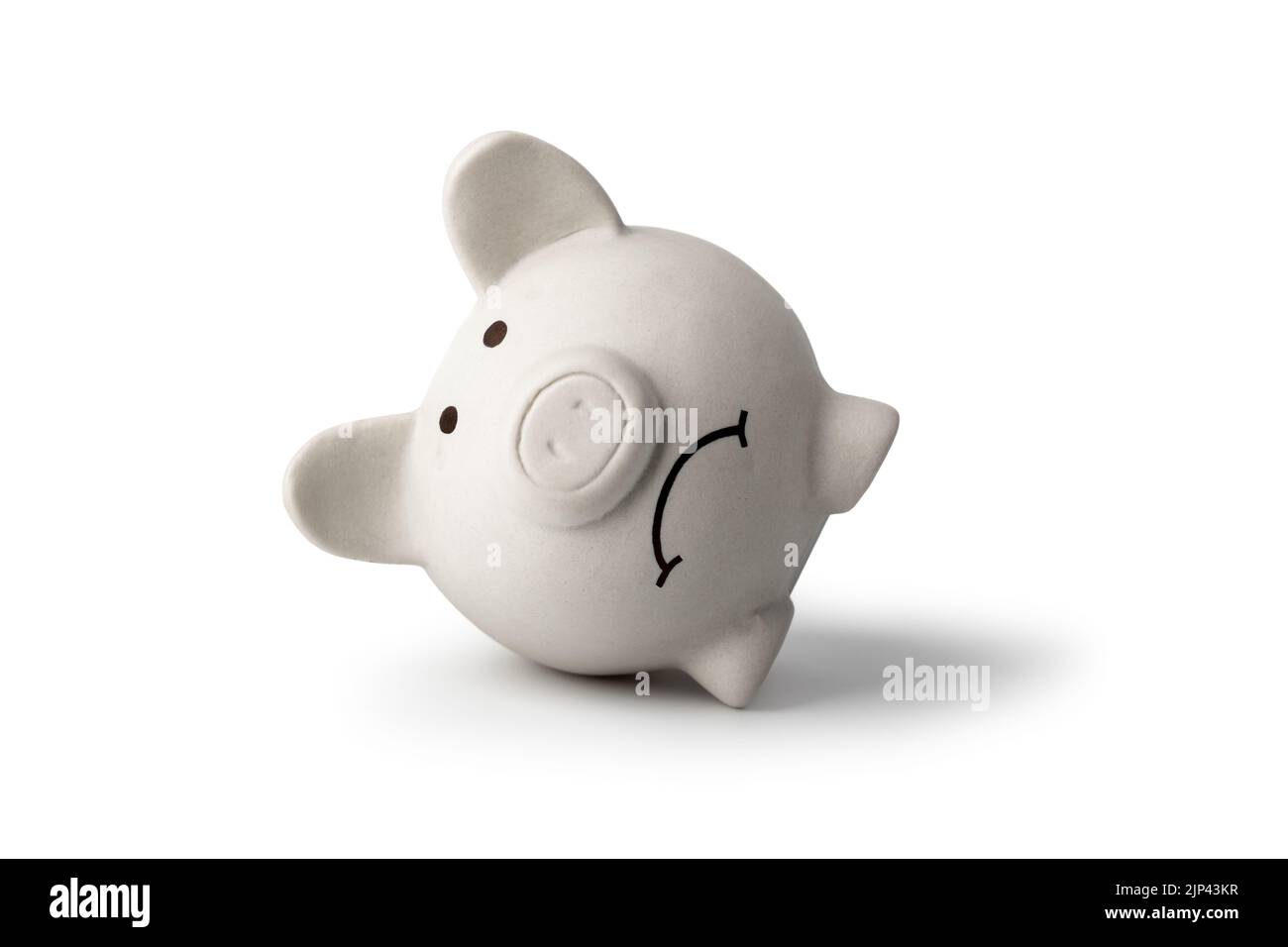 A sad piggy bank isolated on white background, symbolizing the fall of monetary assets. White sadness moneybox. Crisis concept Stock Photo