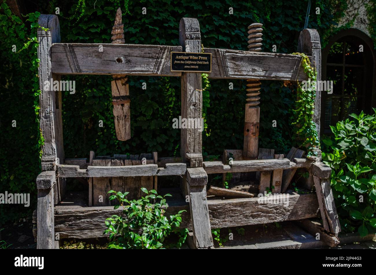 An antique wine press on display at the V. Sattui Winery in The Napa Valley in California, USA Stock Photo