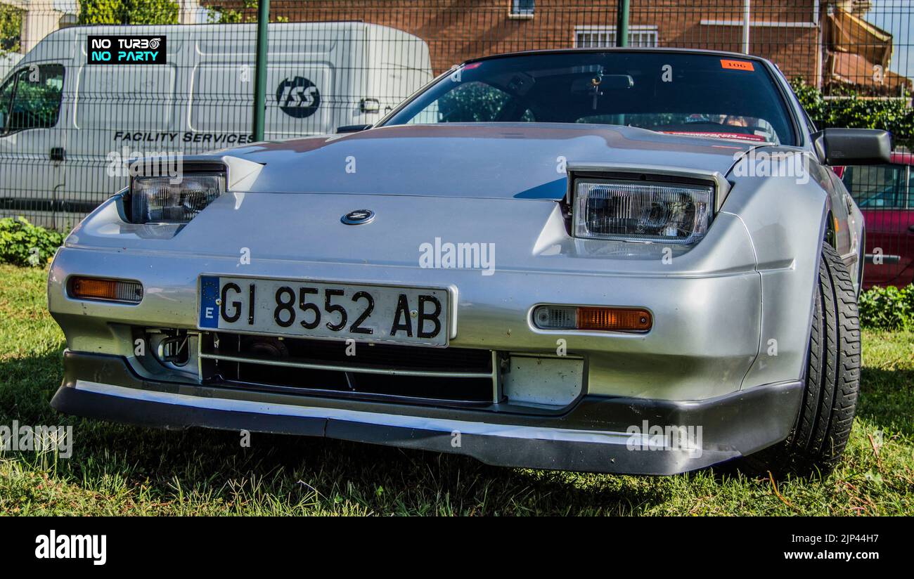 A classic silver sports japan car is parked in the park Stock Photo