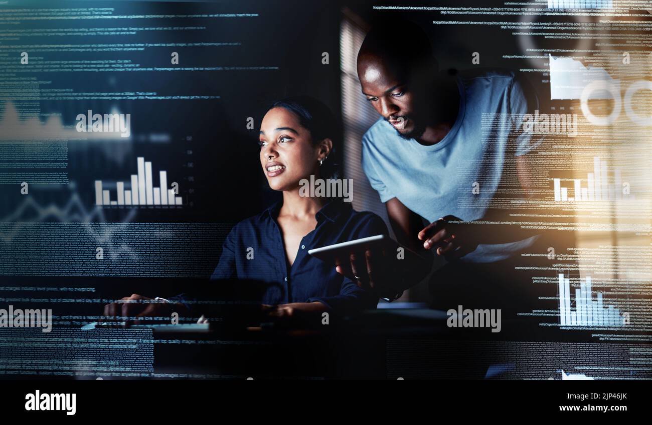 IT or information technology technicians or computer programmers working, coding new user interface or UX late at night in office. Pair of colleagues Stock Photo