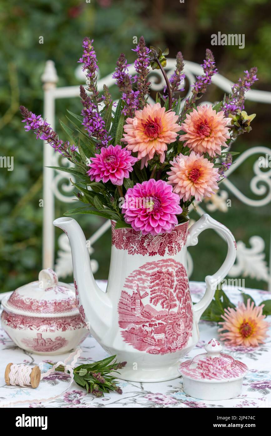arrangement with bouquet of dahlias and meadow sage and vintage porcelain Stock Photo