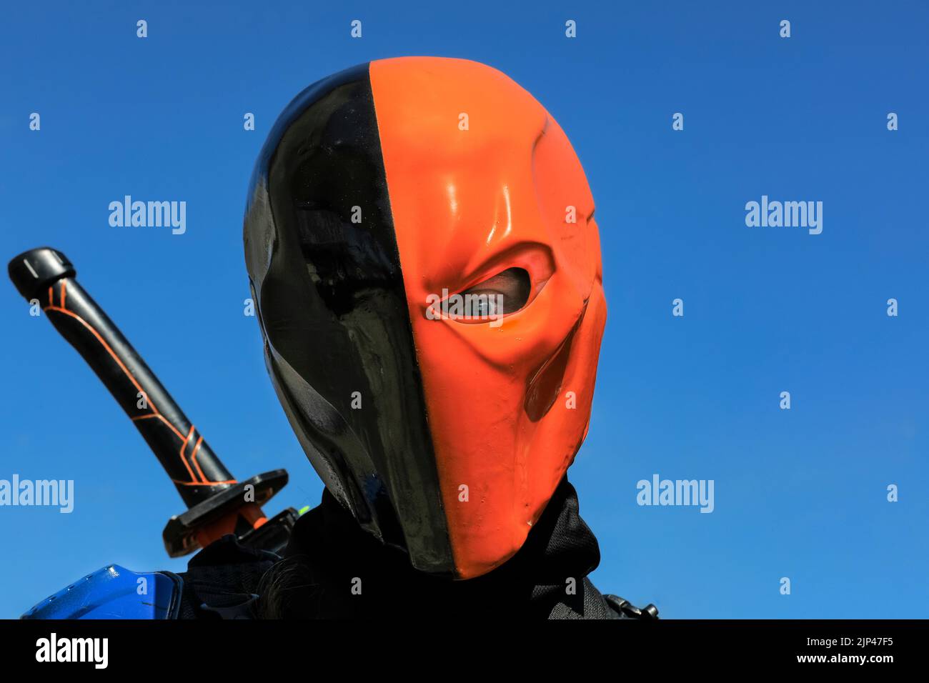 Cosplayer as Deathstroke (Slade Wilson), close up of black and orange