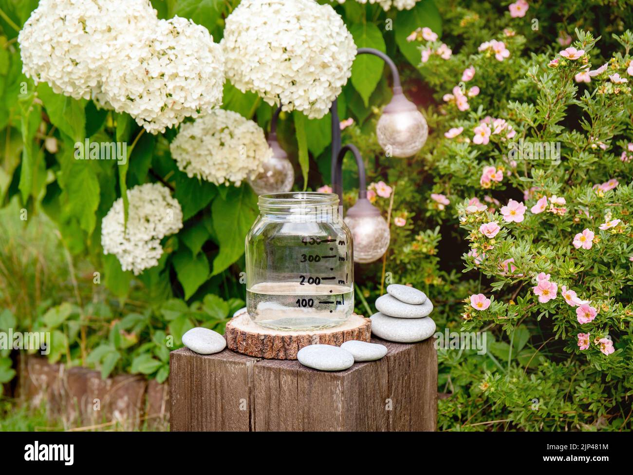 Handmade rain water gauge made of glass jar, measuring rain in home