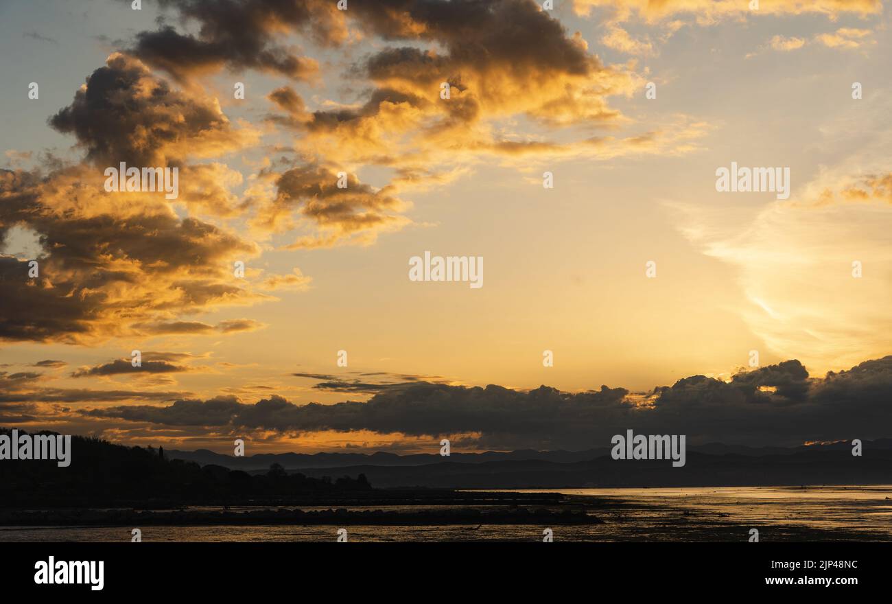 The golden cloudy sunset sky over the sea water by the costs Stock ...