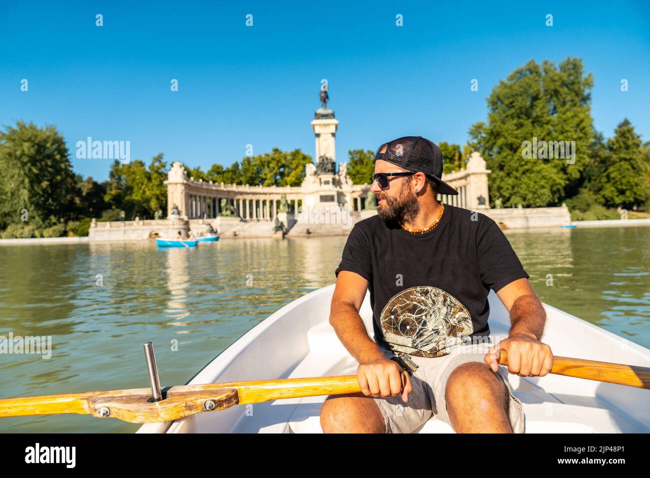 A Caucasian male tourist rowing the boat in the Estanque Grande de El