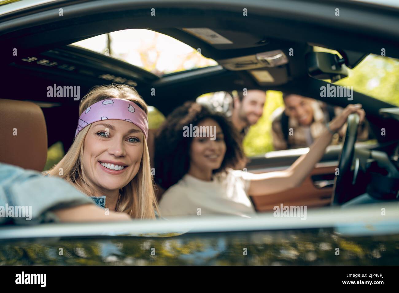 Girls in the car flirting with men on the road Stock Photo - Alamy