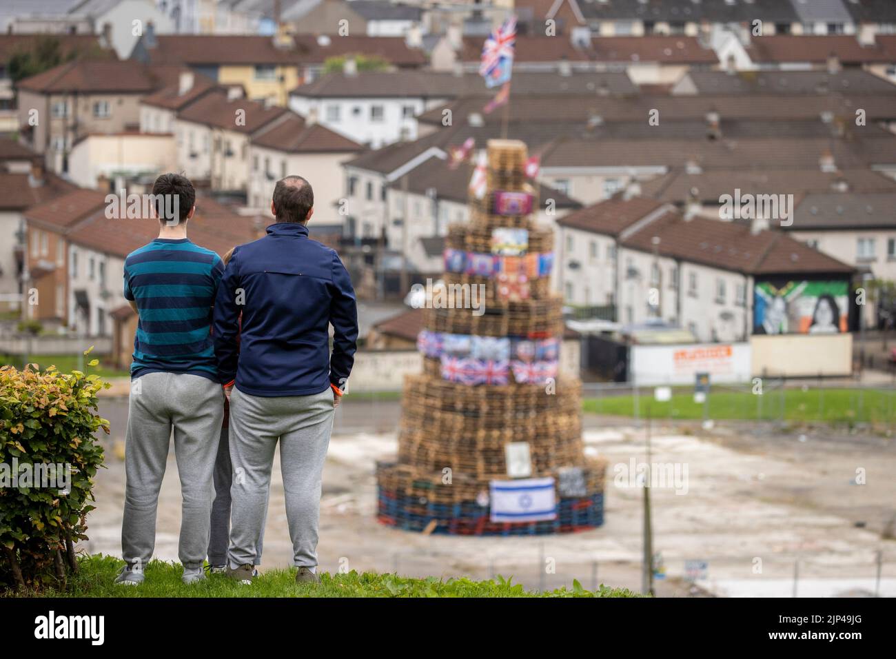 NOTE LANGUAGE ON BANNER People View A Bonfire Stack Prior To It Being Note language on banner people view a bonfire stack prior to it being