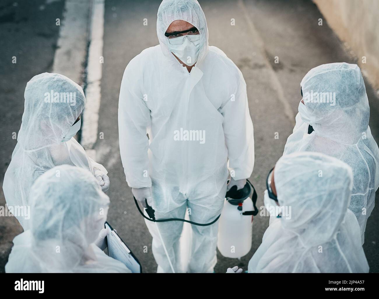 Covid pandemic outbreak team of doctors or medical workers wearing protective ppe to prevent spread of virus outside. Group of scientists wearing Stock Photo