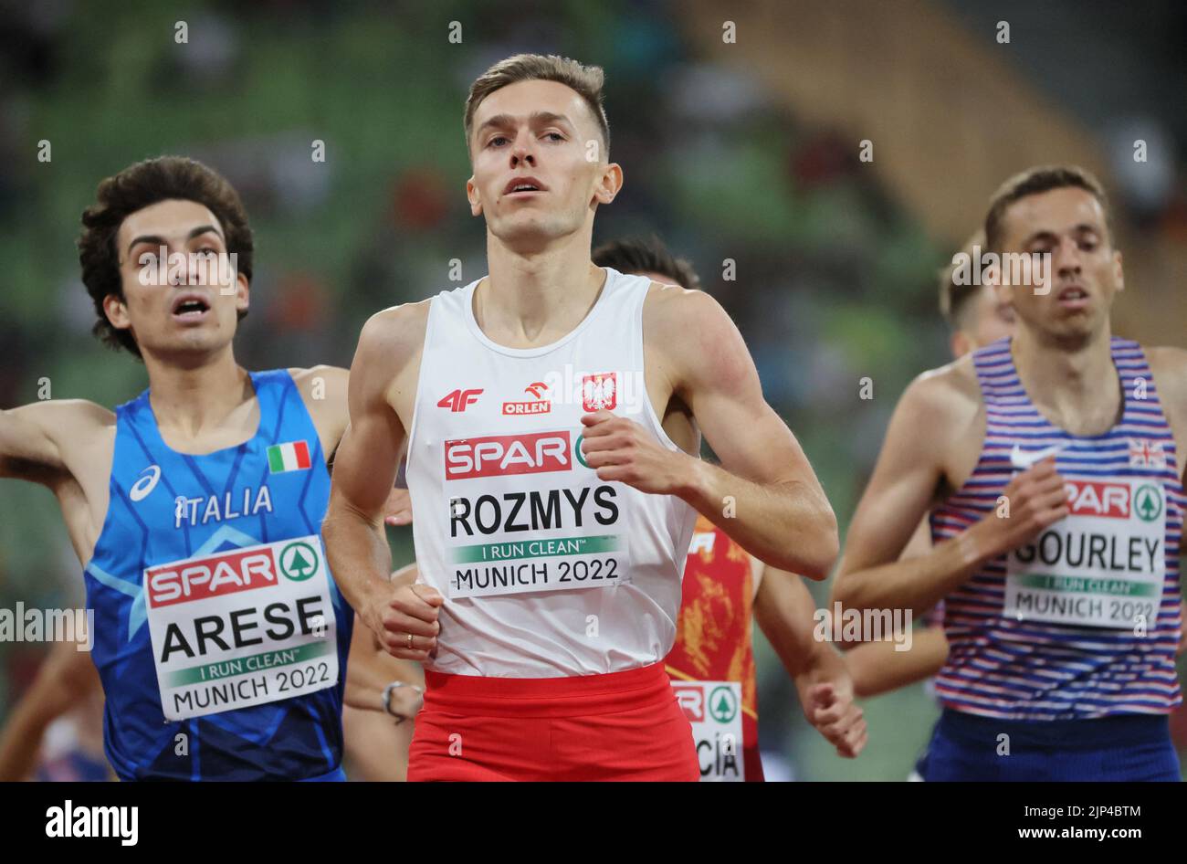 Athletics - 2022 European Championships - Olympiastadion, Munich, Germany - August 15, 2022  Poland's Michal Rozmys crosses the line to win the men's 1500 metres heat 2 ahead of second place Italy's Pietro Arese REUTERS/Wolfgang Rattay Stock Photo