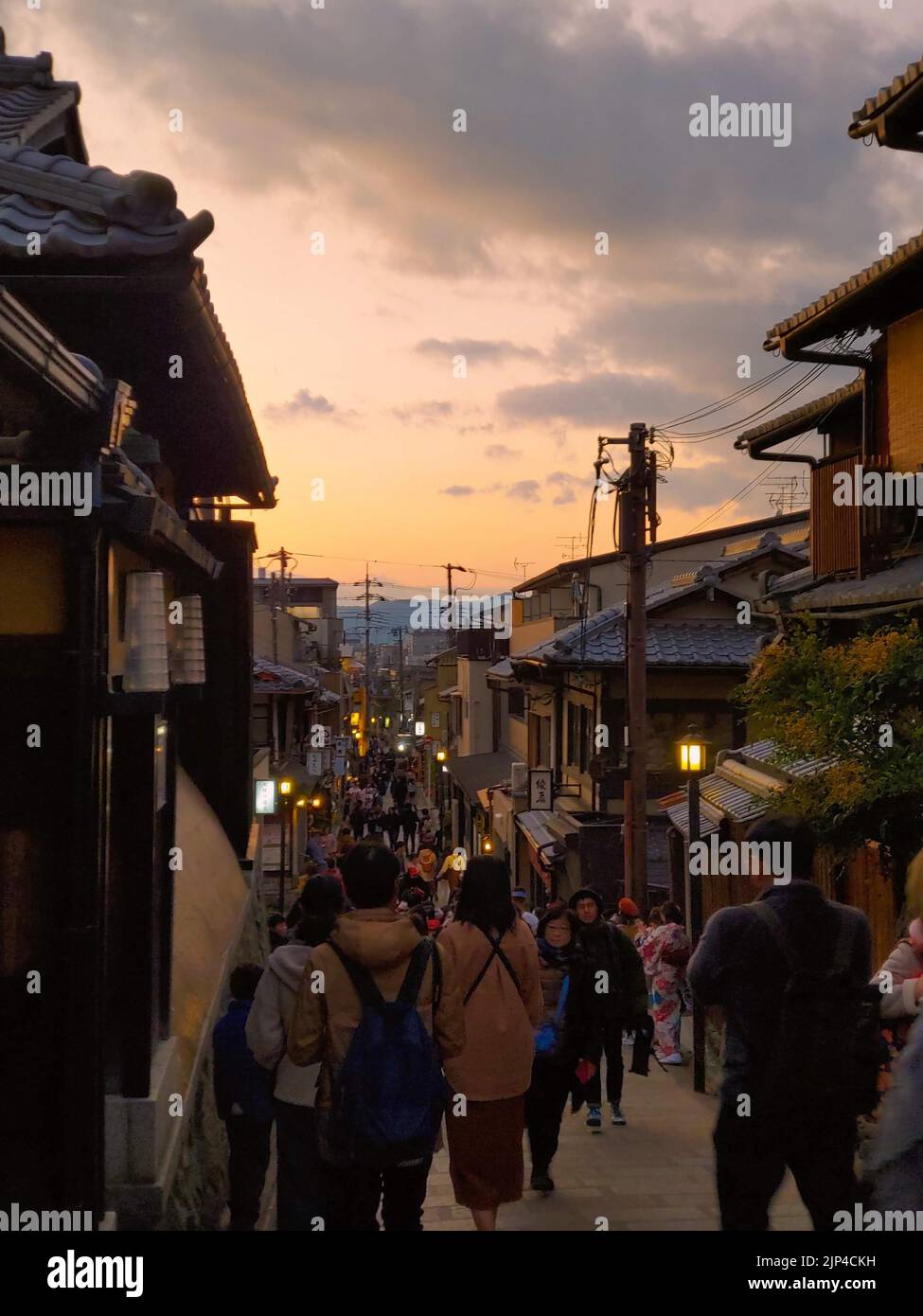 The crowded Sannenzaka stone-paved pedestrian road during sunset in Higashiyama-ku, Kyoto, Japan Stock Photo