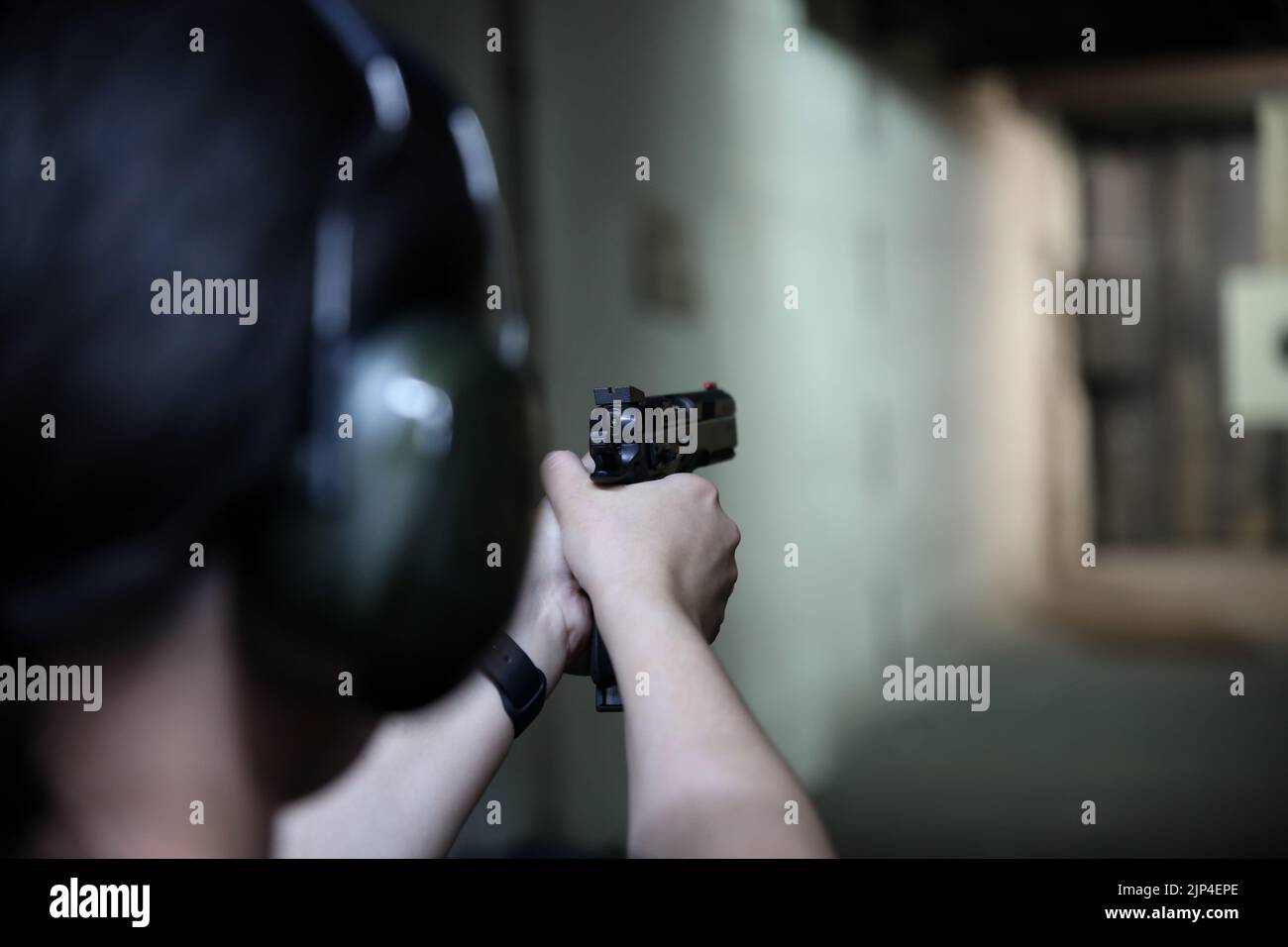 Woman Weapon bullseye target training in a shooting club Stock Photo Alamy