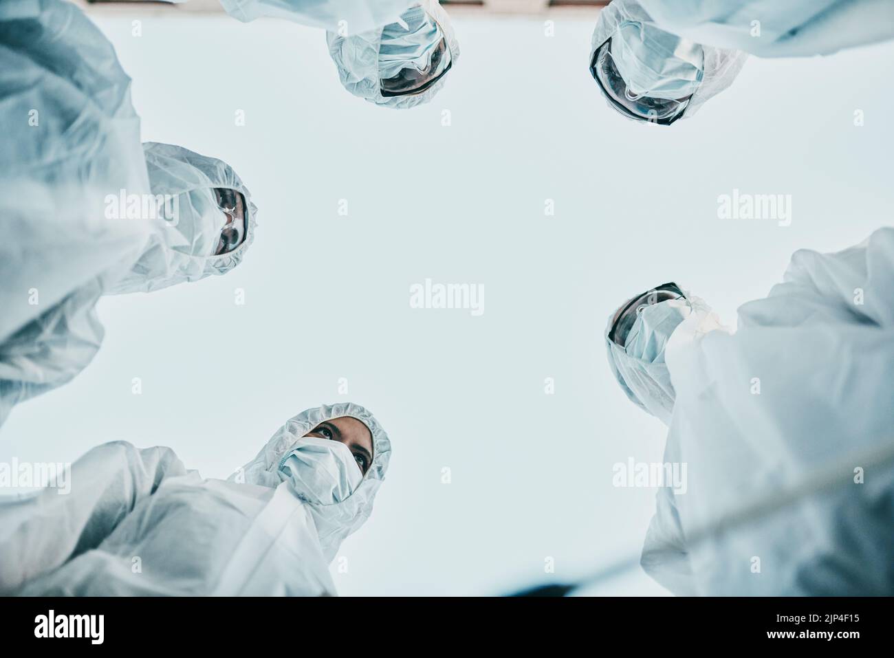 Covid pandemic outbreak team of doctors or medical workers wearing protective ppe to prevent spread of virus in hospital. Group of scientists wearing Stock Photo