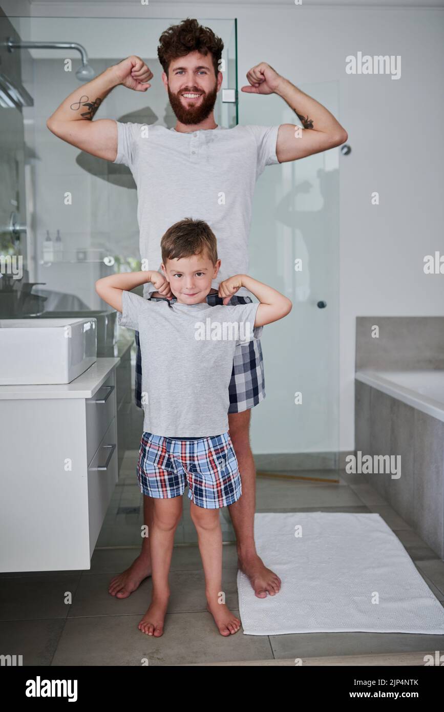 Check out these babies. Portrait of a father and his little son flexing