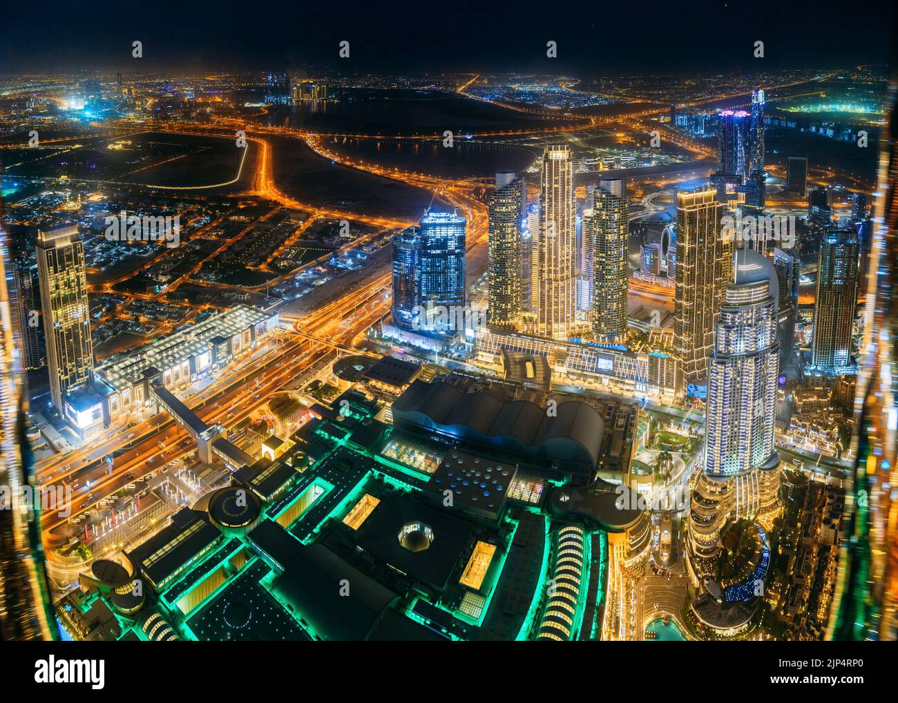 Aerial view of evening night illuminations scenic view of skyscraper in Dubai. Street night traffic in Dudai skyline. Urban background of Dubai, UAE Stock Photo
