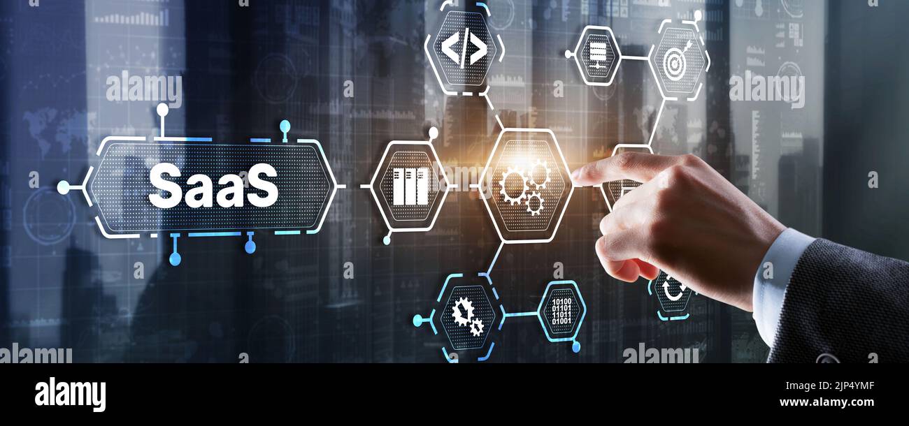SaaS Software as a Service concept with man hand pressing text Stock Photo
