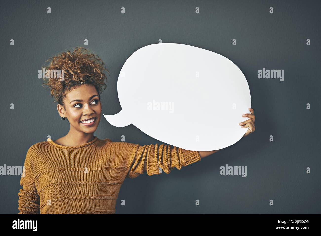 Woman holding speech bubble, chat board and blank copy space poster for voicing opinions, talking on social media or sharing ideas. Creative speaking Stock Photo
