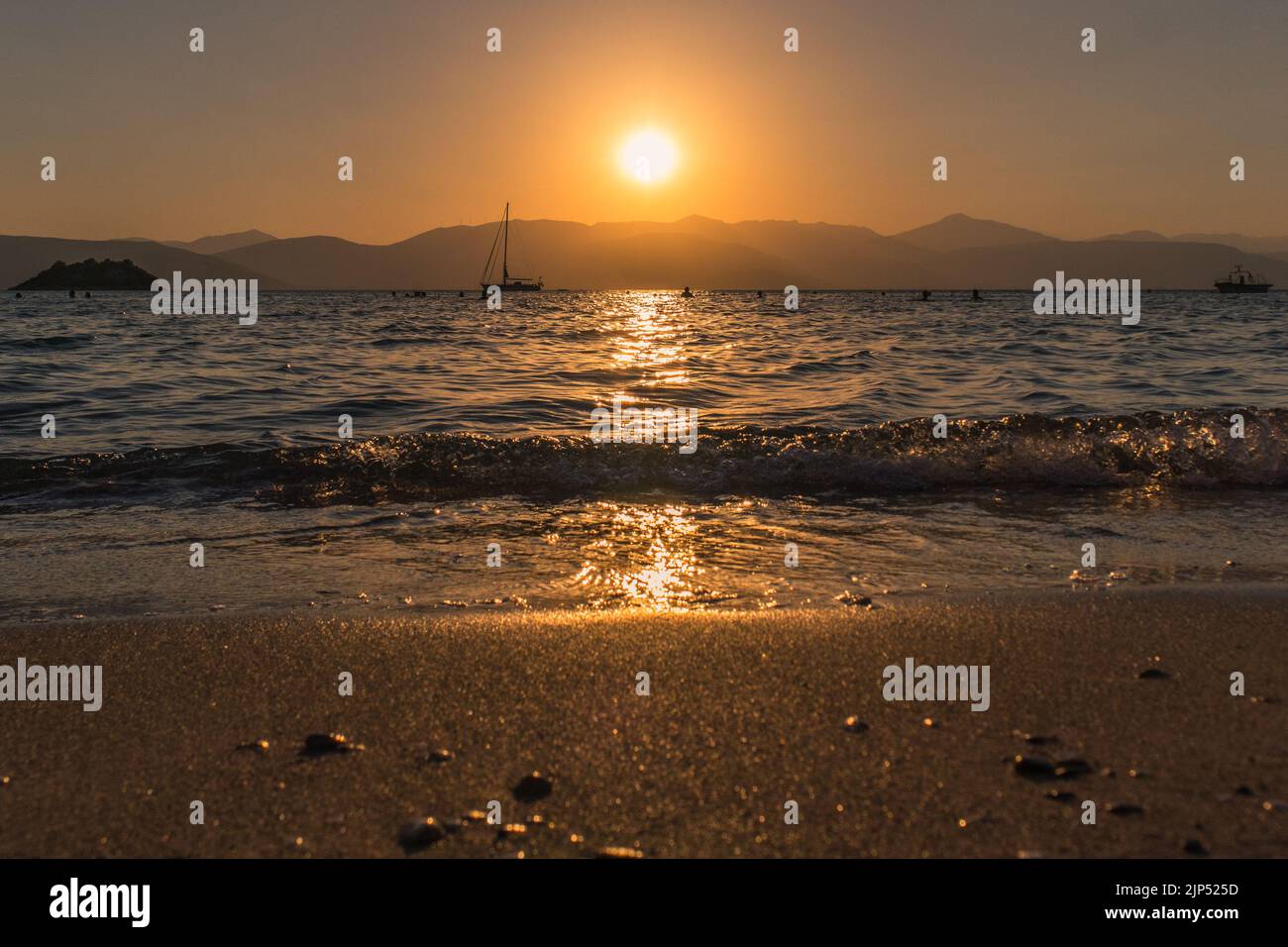 A beautiful golden sunset sky over the seashore in Argolis, Greece ...