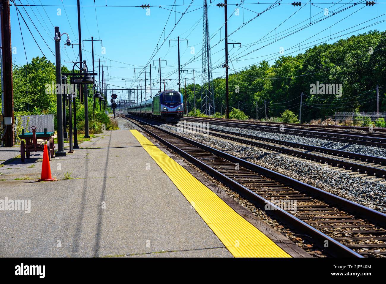 Perryville, MD, USA – August 13, 2022: An Amtrak passenger train traveling through a small Maryland town about to cross over the Susquehanna River. Stock Photo