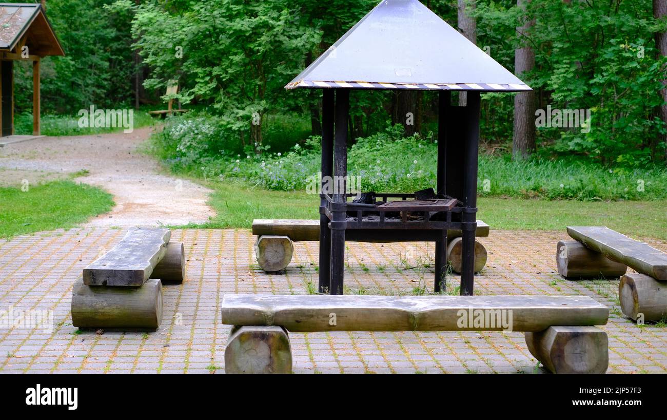 Barbecue with a roof for barbecue in the forest park area Stock Photo