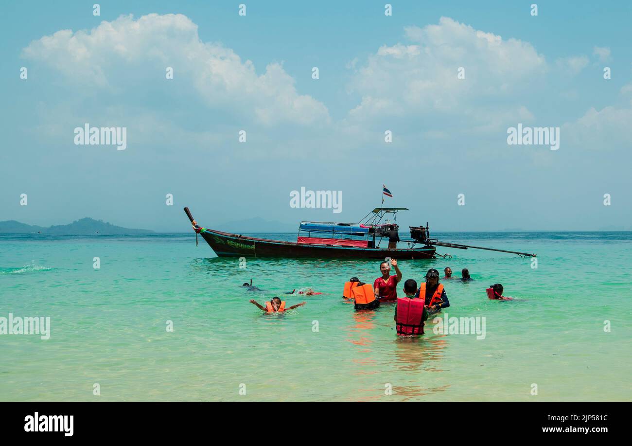 Beach on Koh Kradan Island in the Andaman Sea. Traditional Thai boats