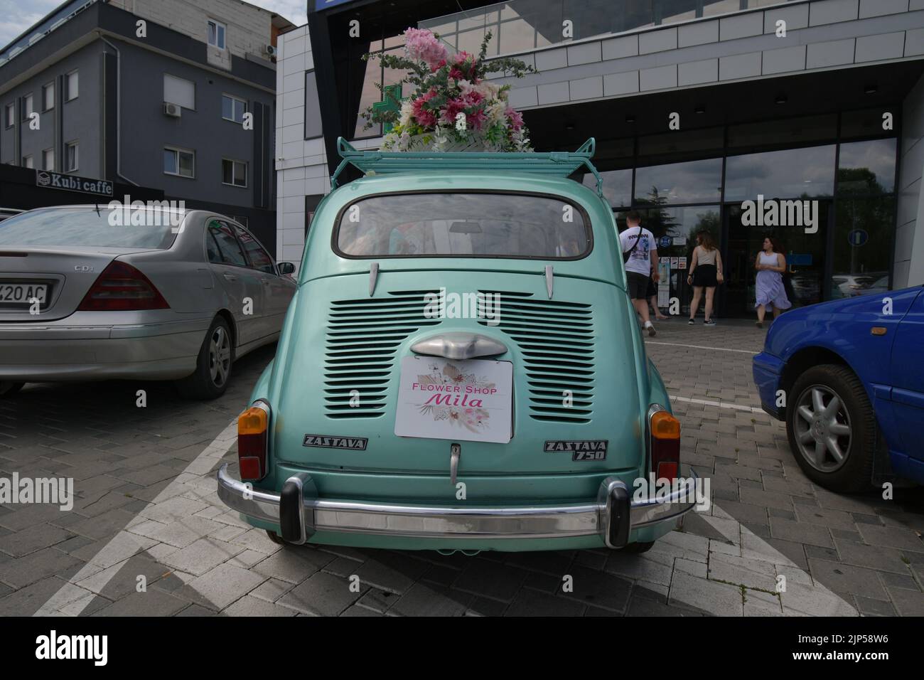 The legendary car supermini Zastava 750 (Fiat 600) which was produced from 1955 to 1985 parked in the front of the flower shop, decorated with flowers Stock Photo