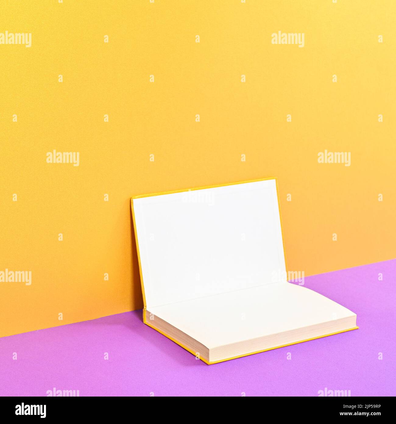 Creative background with copy space open hardcover book on golden