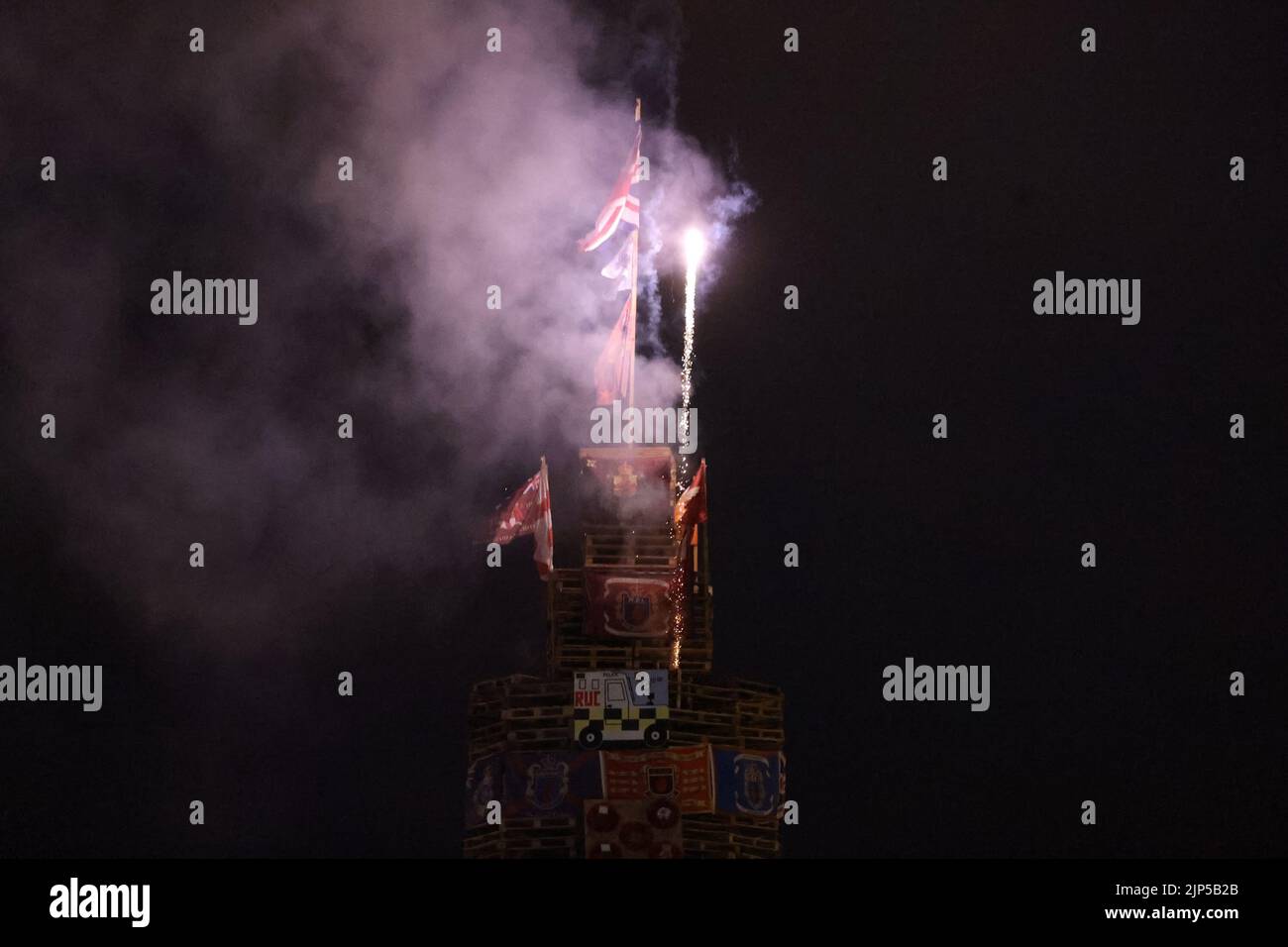 Fireworks are let off ahead of the lighting of a bonfire stack to mark the Catholic Feast of the Assumption in the Bogside area of Londonderry, Northern Ireland. Picture date: Monday August 15, 2022. Stock Photo