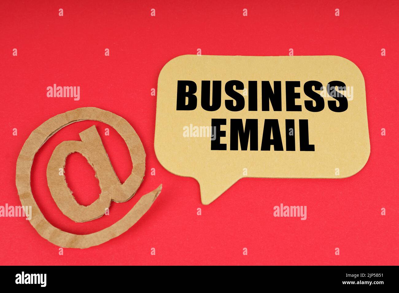 Email and business. On a red surface, a symbol and a sign with the ...