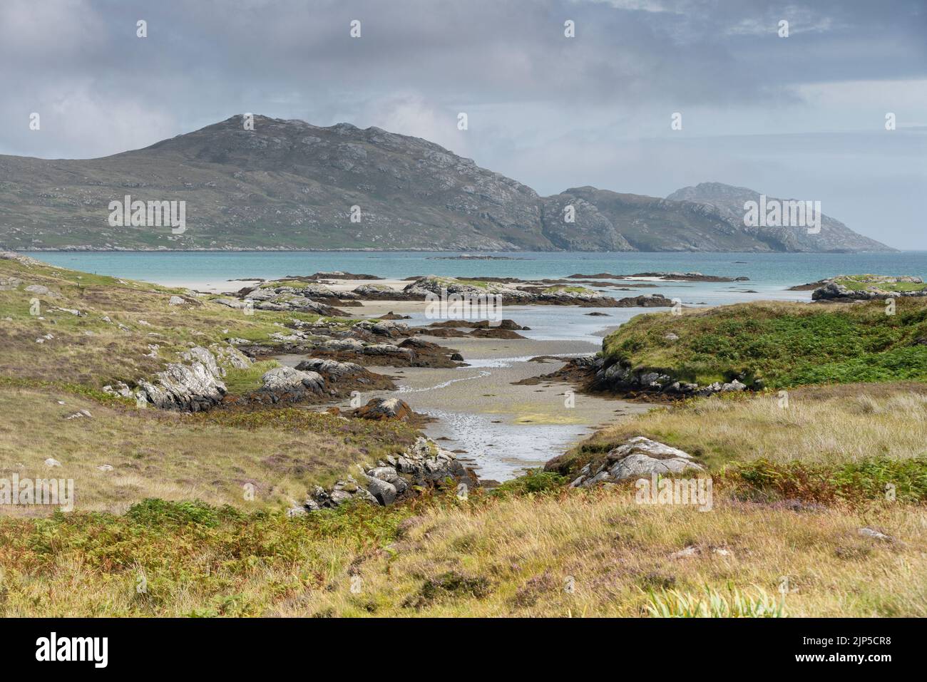 The hills of South Uist, seen from Taobh a' Chaolais, adjacent to the causeway to the Isle of Eriskay. Ròineabhal is one of the hills depicted. Stock Photo