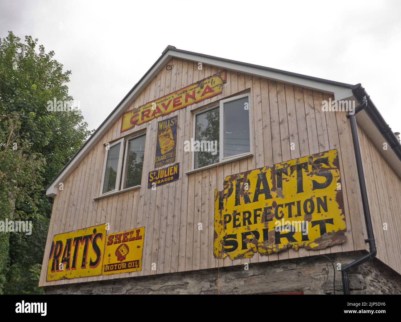 Vintage signs advertising oil and tobacco at a garage in Shrewsbury, Shropshire,England,UK Stock Photo