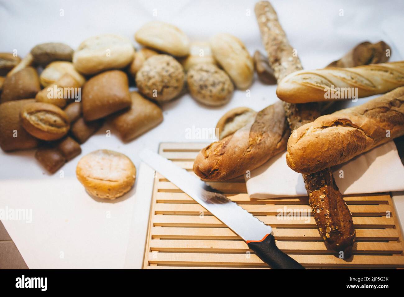 Different types of bread on the table in the kitchen. Stock Photo
