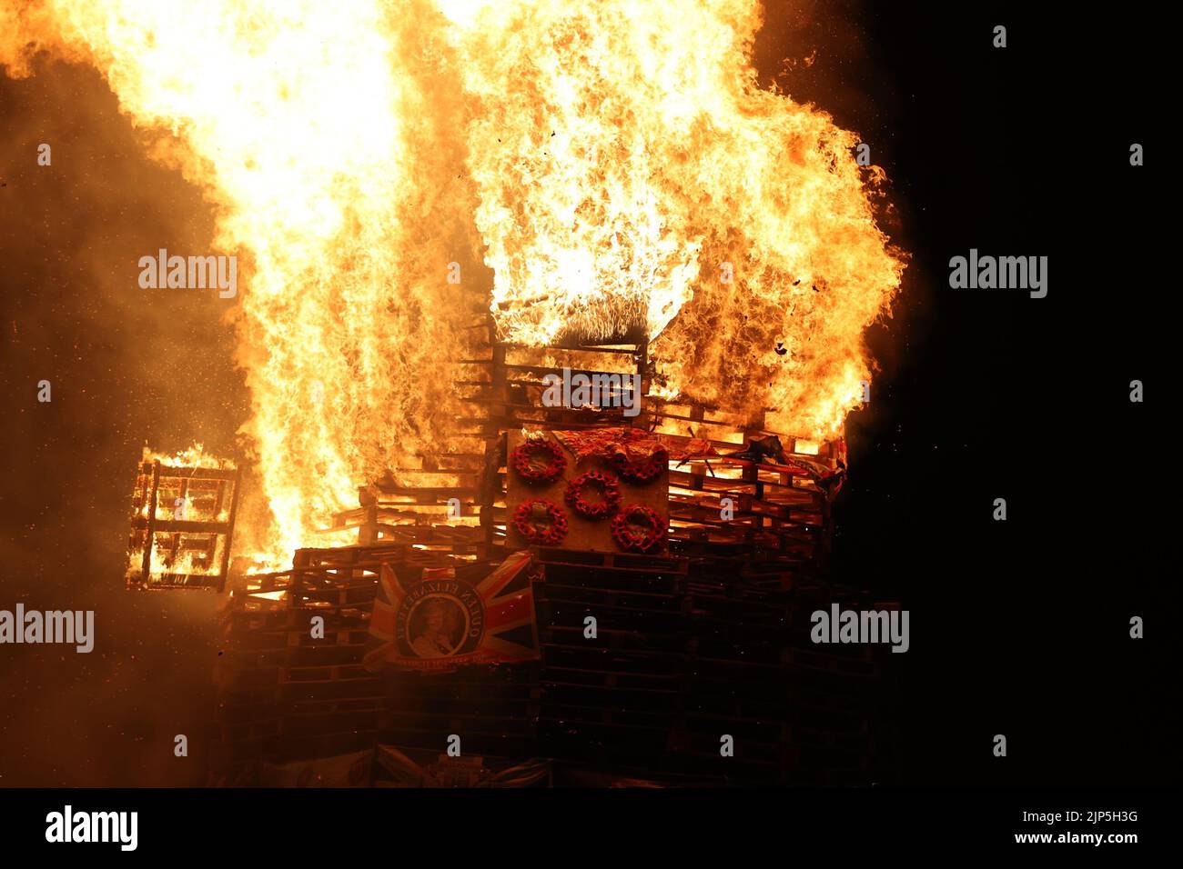 The burning of a bonfire to mark the Catholic Feast of the Assumption in the Bogside area of Londonderry, Northern Ireland. Picture date: Monday August 15, 2022. Stock Photo