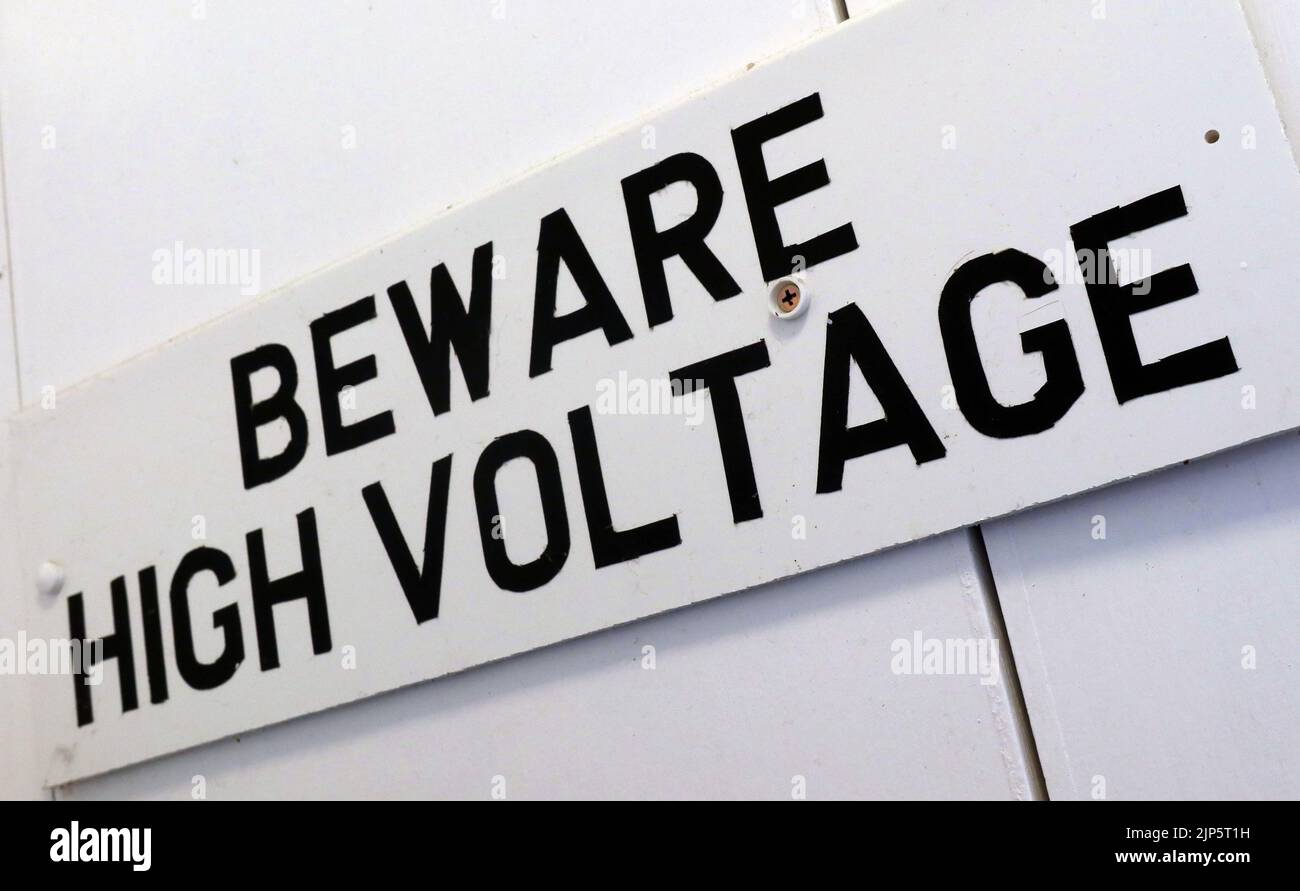 Beware High Voltage sign - Electrical health and safety hazard, written in English Stock Photo