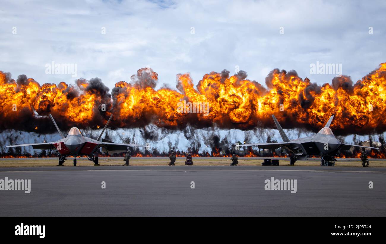 The “Wall of Fire” explodes behind two U.S. Air Force F22 Raptors