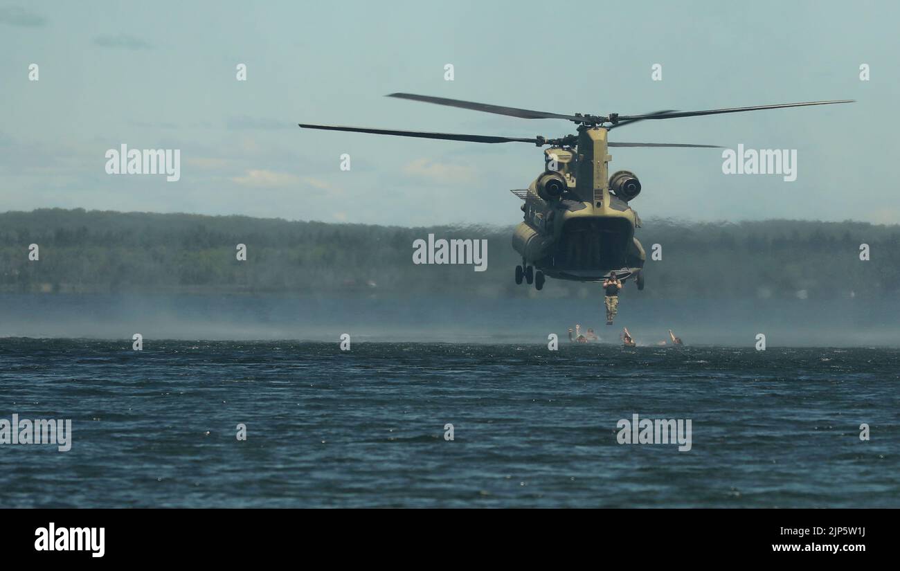 U.S. Army Soldiers with 20th Special Forces Group (Airborne), Alabama National Guard, and 2nd Squadron, 107th Cavalry Regiment, Ohio National Guard, conduct helocast operations from a CH-47 Chinook helicopter into Lake Margrethe during Northern Strike at Camp Grayling, Mich., Aug. 11, 2022. Northern Strike is designed to challenge approximately 7,400 service members with multiple forms of training that advance interoperability across multicomponent, multinational and interagency partners. (U.S. Army National Guard photo by Staff Sgt. Tegan Kucera) Stock Photo