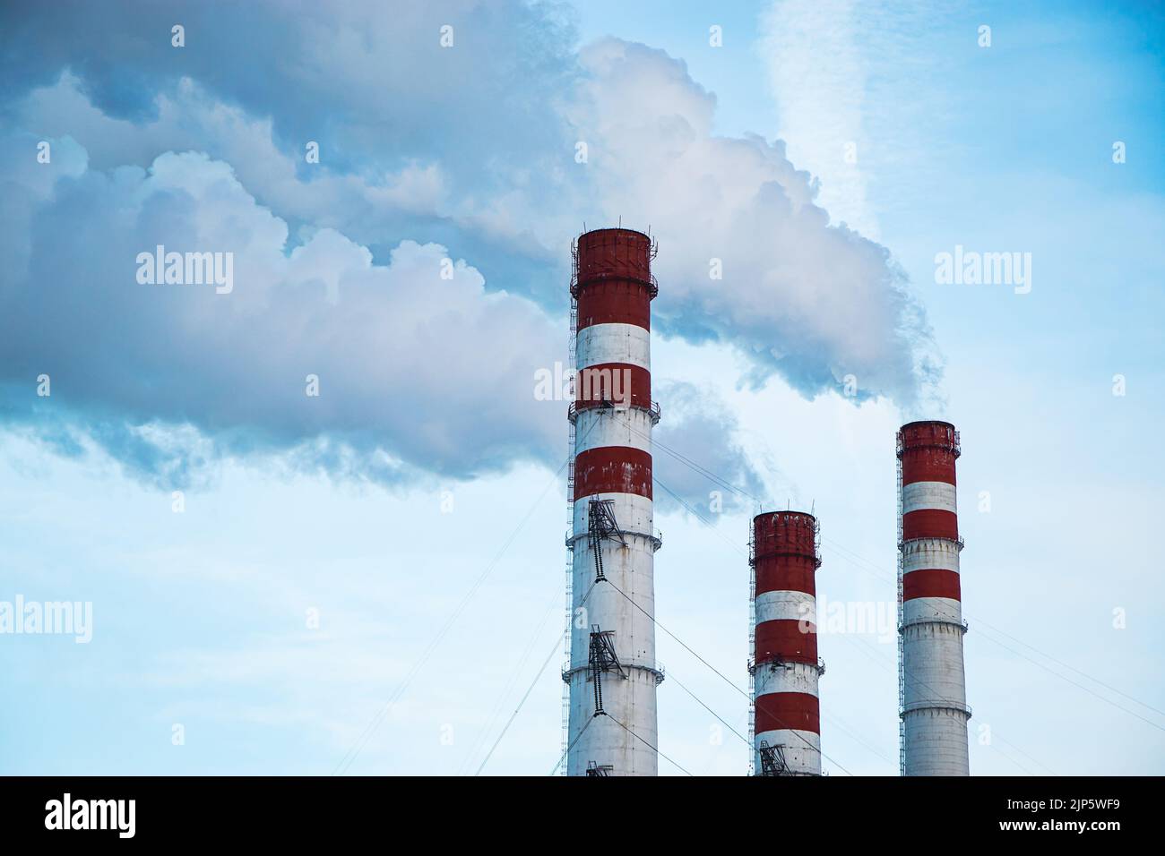 Air pollution. Thick smoke from chimneys in industrial plant