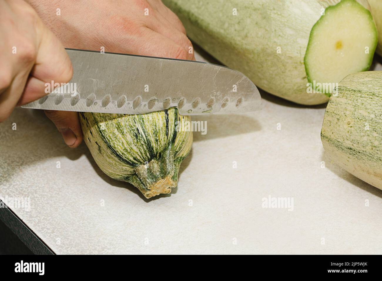 Premium Photo  Peeling fresh green zucchini with peeler. process