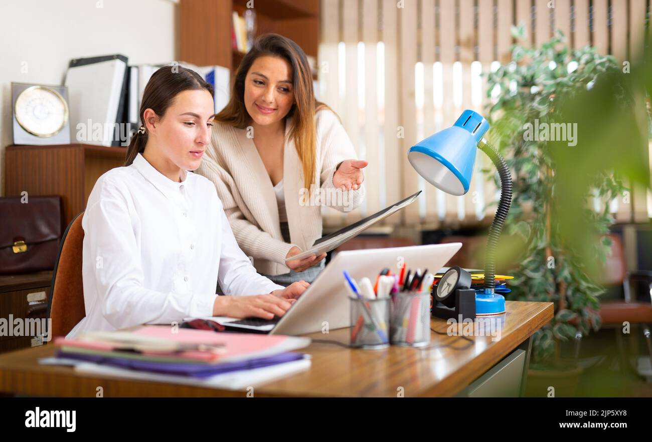 Business woman with assistant working at office Stock Photo - Alamy