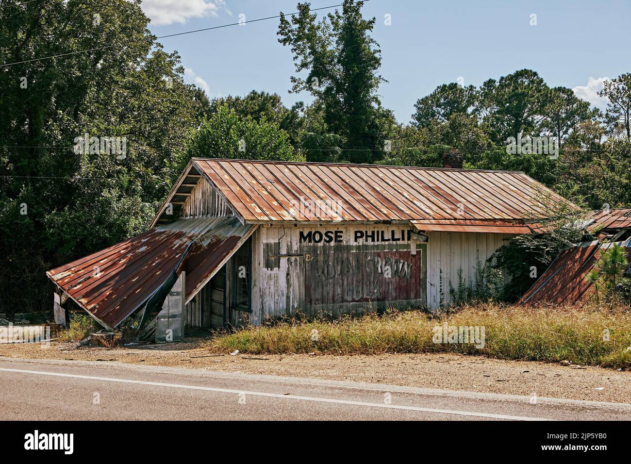 Rustic collapsing or dilapidated old building with a rusting metal roof in rural Smuteye Alabama, USA. Stock Photo