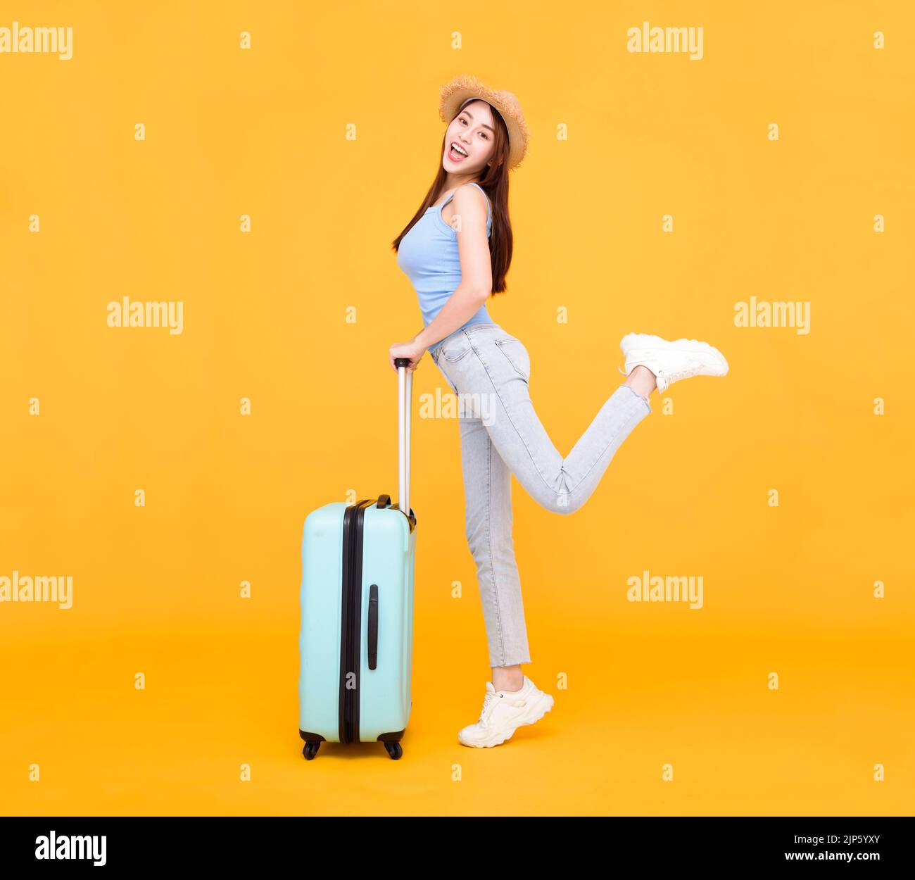 Happy young woman with  luggage isolated on yellow background ,summer,travel concept. Stock Photo