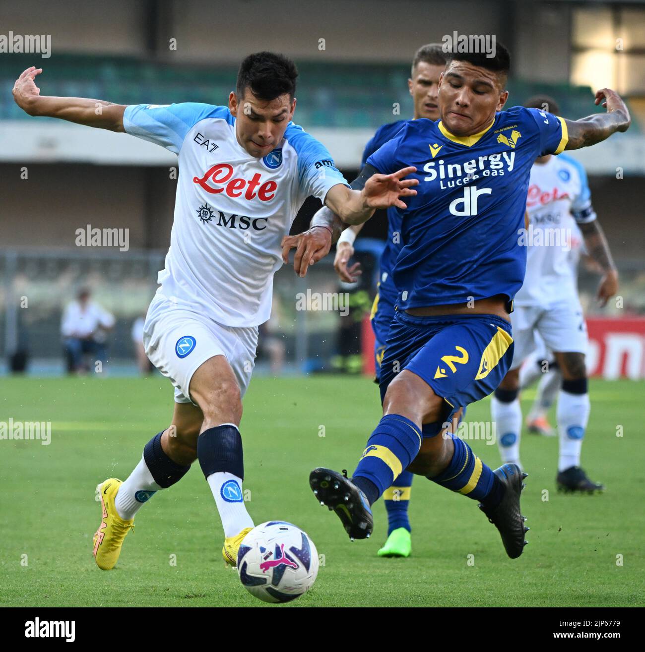 Verona, Italy. 15th Aug, 2022. Napoli's Hirving Lozano (L) vies with Hellas Verona's Bruno Amione during a Serie A football match between Napoli and Hellas Verona in Verona, Italy, on Aug. 15, 2022. Credit: Alberto Lingria/Xinhua/Alamy Live News Stock Photo