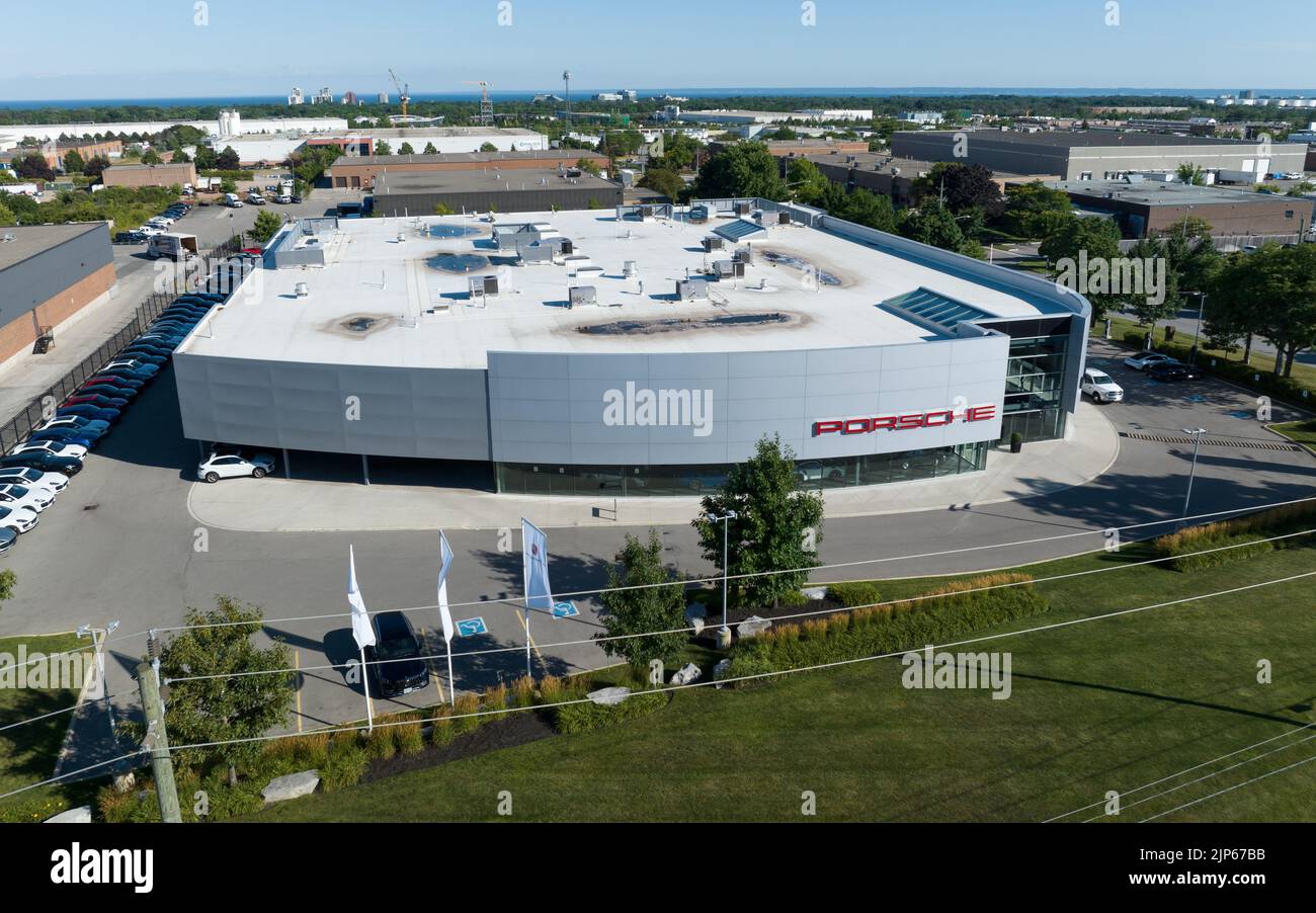 An aerial view of the front of a modern Porsche dealership in Canada. Porsche is a German automobile manufacturer of high-performance cars. Stock Photo
