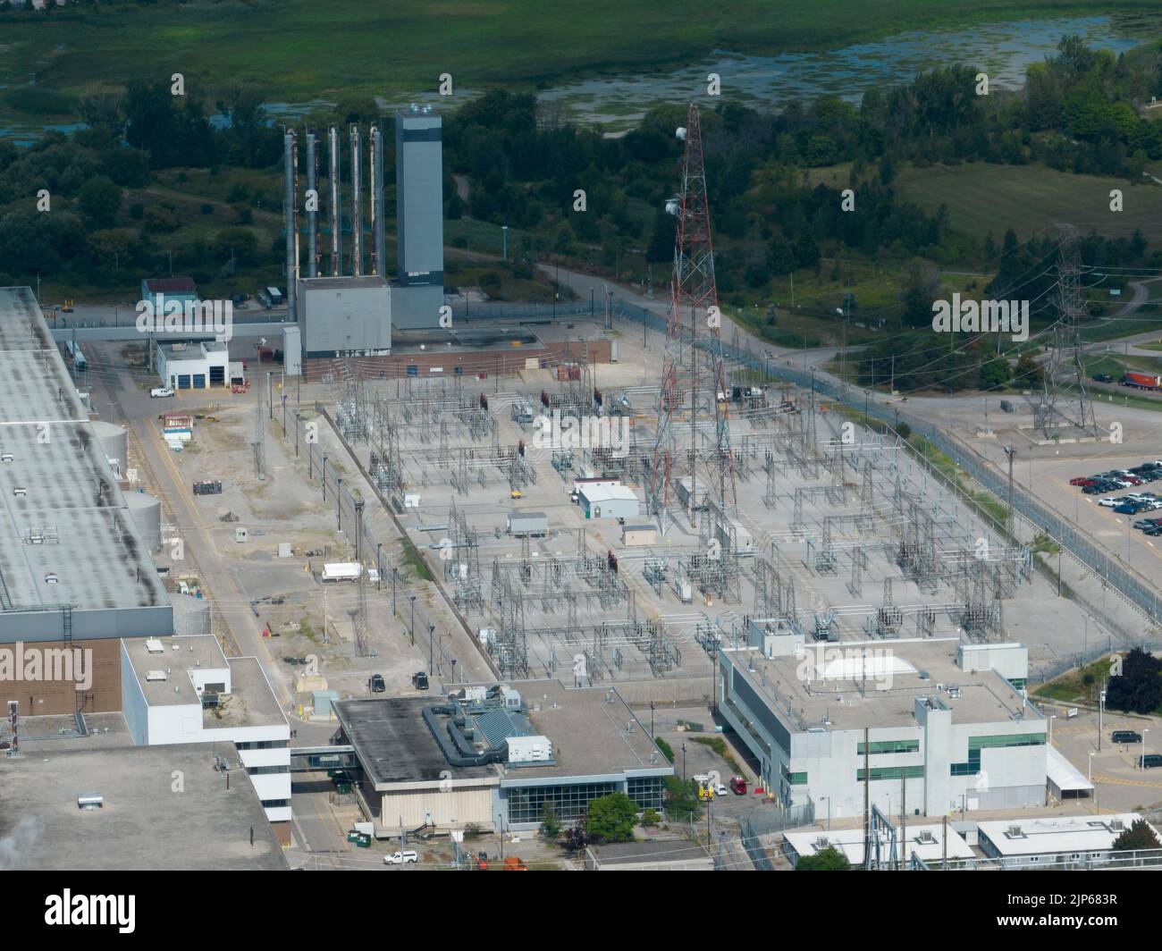 A high-angle aerial view looking at an electrical transformer, power grid station. Seen on a sunny day. Stock Photo