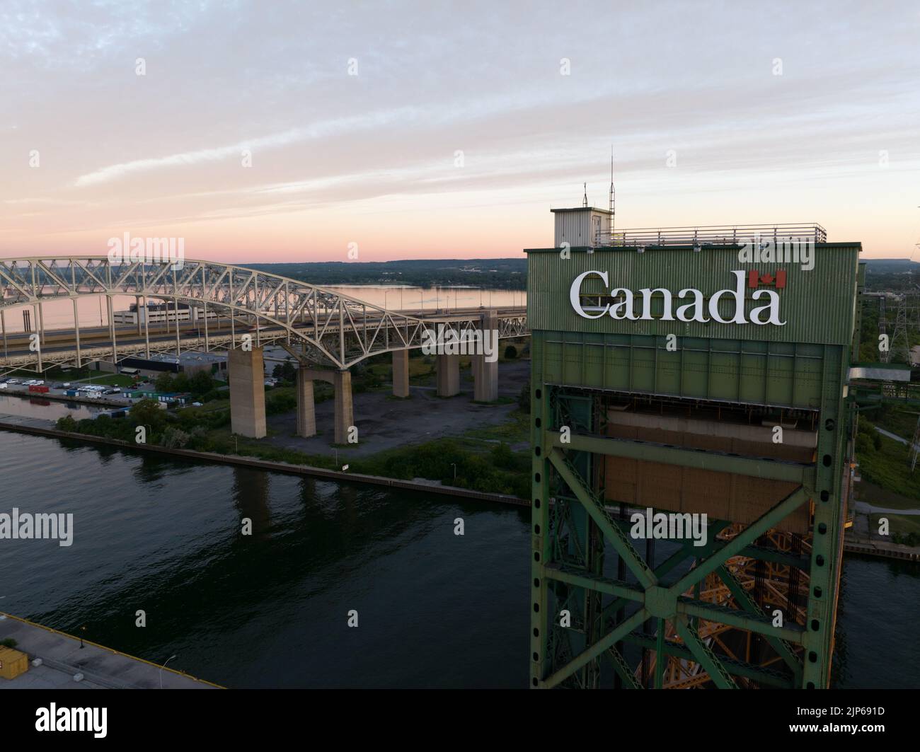 An aerial view closeup of the Government of Canada logo on a drawbridge at the inlet to the Port of Hamilton in the early morning. Stock Photo