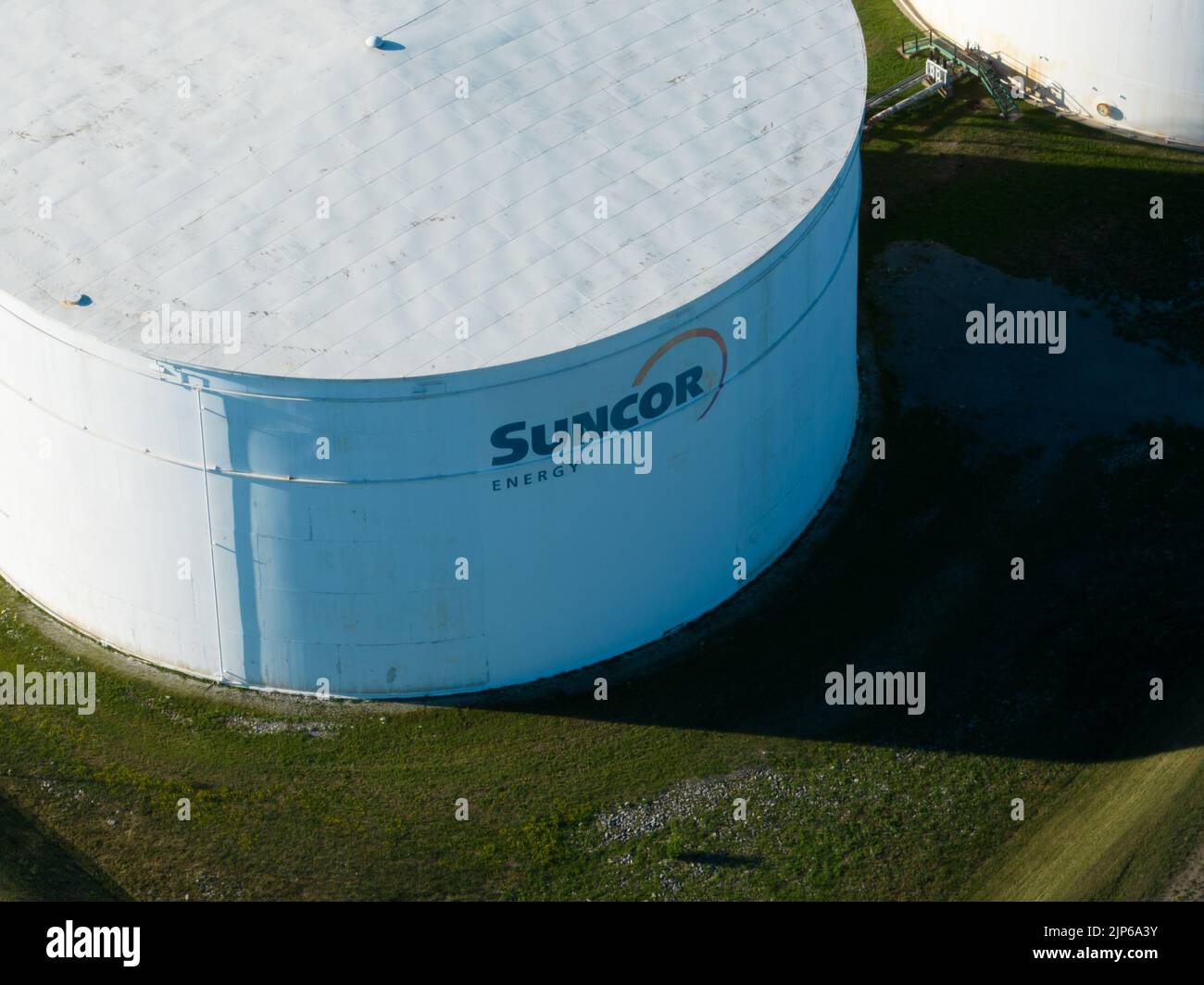 A closeup of the Suncor Energy logo, a Canadian integrated energy company, on a crude oil storage tank on a sunny day. Stock Photo