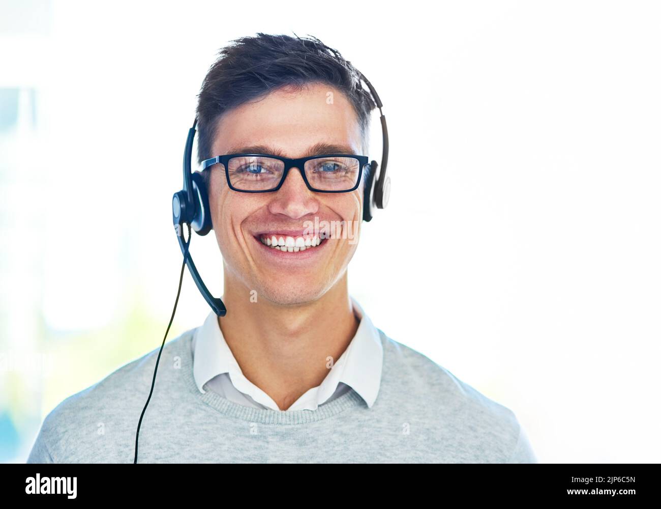 Committed to customer care. Portrait of a young call center agent