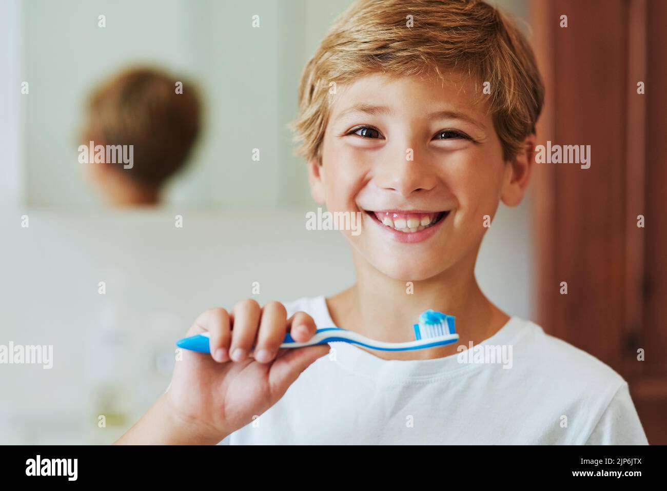 Keep your smile bright by brushing your teeth. Portrait of a cheerful