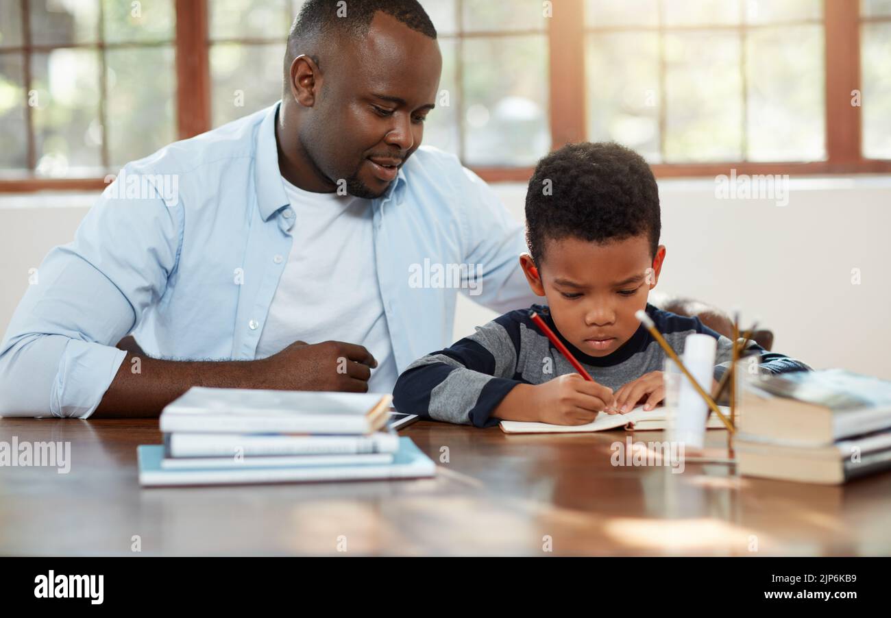 Dads here if you get stuck. a handsome young father helping his son ...