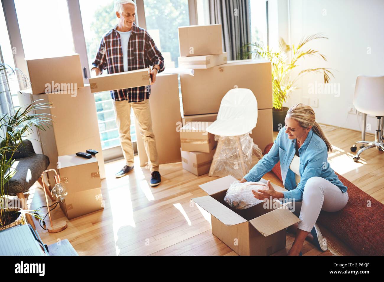 Teamwork makes moving day work. a mature couple packing boxes on moving day Stock Photo Alamy