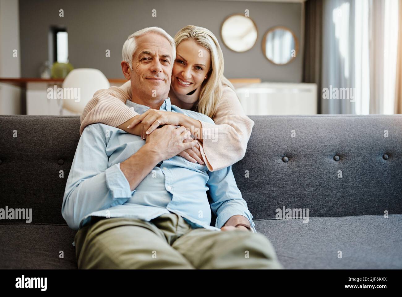 Hugging A Lod Love each other...a lot. a mature woman hugging her husband on the sofa ...